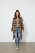 Calendula-shop long brown plaid polyester coat worn by a smiling woman with jeans and a beige sweater