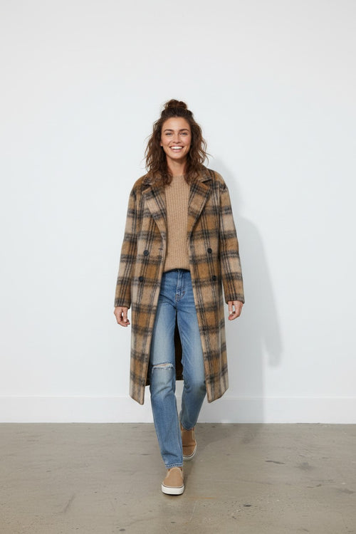 Calendula-shop long brown plaid polyester coat worn by a smiling woman with jeans and a beige sweater