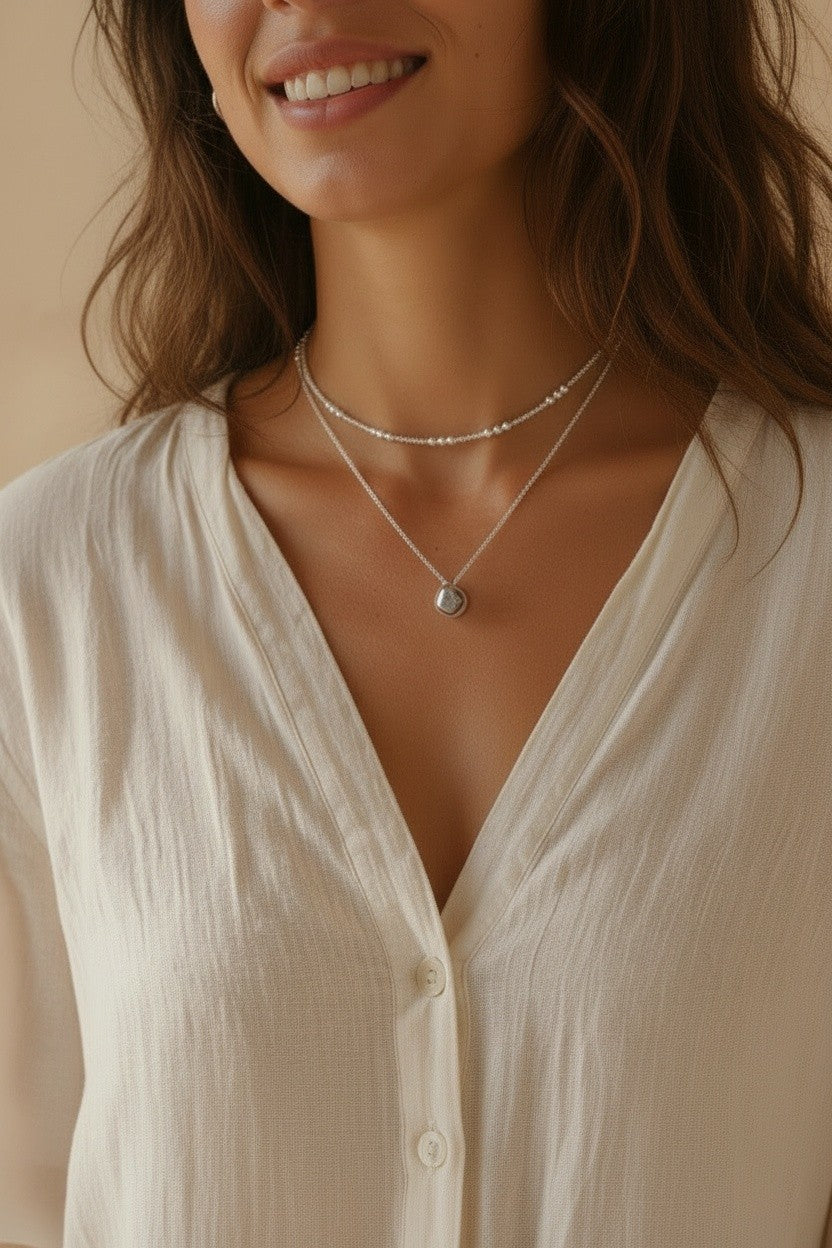 Cadena de plata Calendula-shop con pequeñas bolitas intercaladas, diseño minimalista y elegante sobre modelo