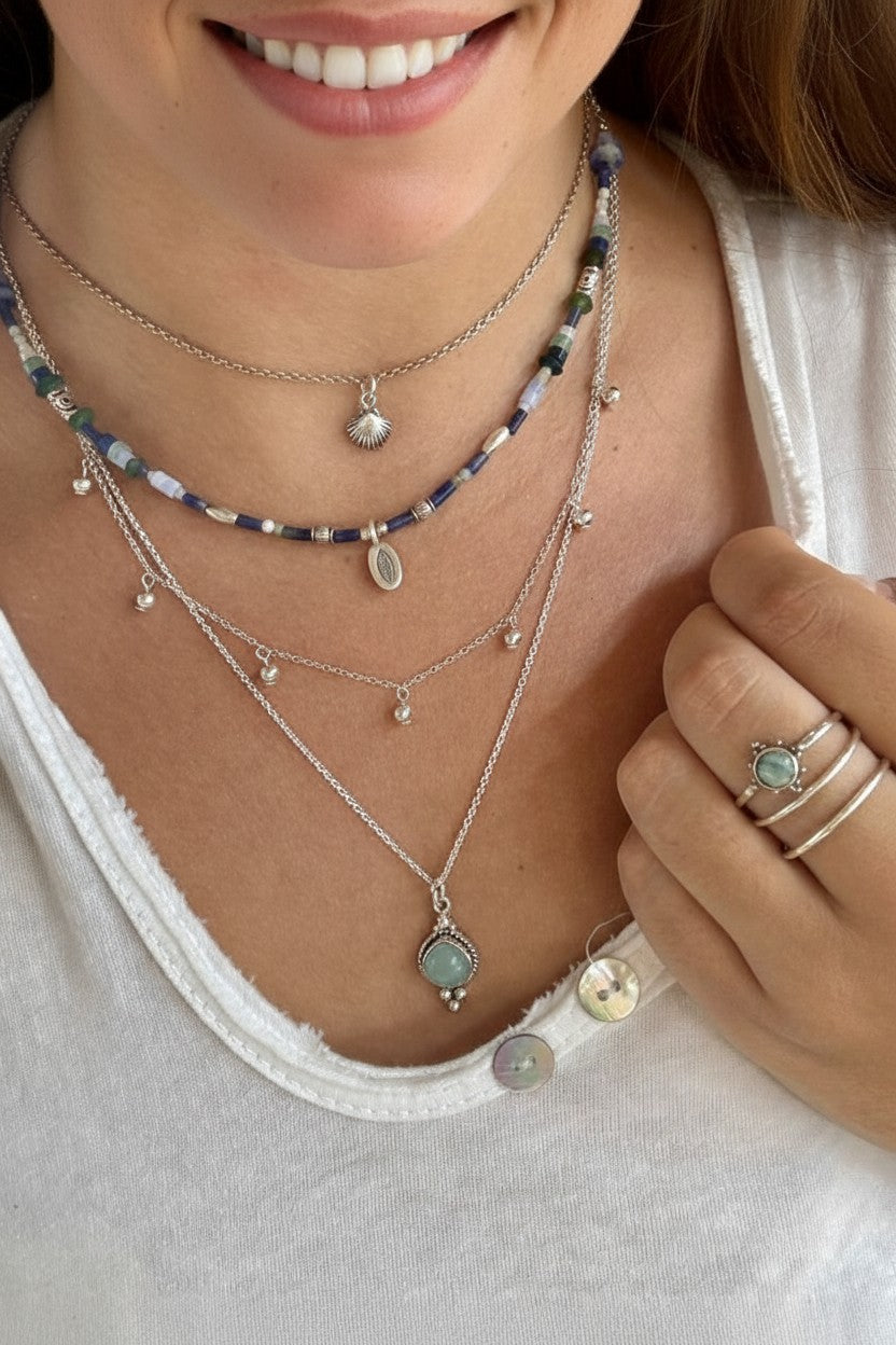 Colgante Venus de Calendula-shop con piedra natural de calcedonia y cadena de plata de ley sobre cuello femenino