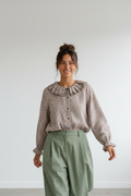 Calendula-shop Julieta long-sleeve blouse in brown gingham check with a ruffled round collar and button-down front.