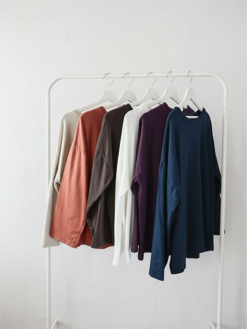 Calendula-shop Marta long sleeve cotton shirts in various colors hanging on a white clothing rack