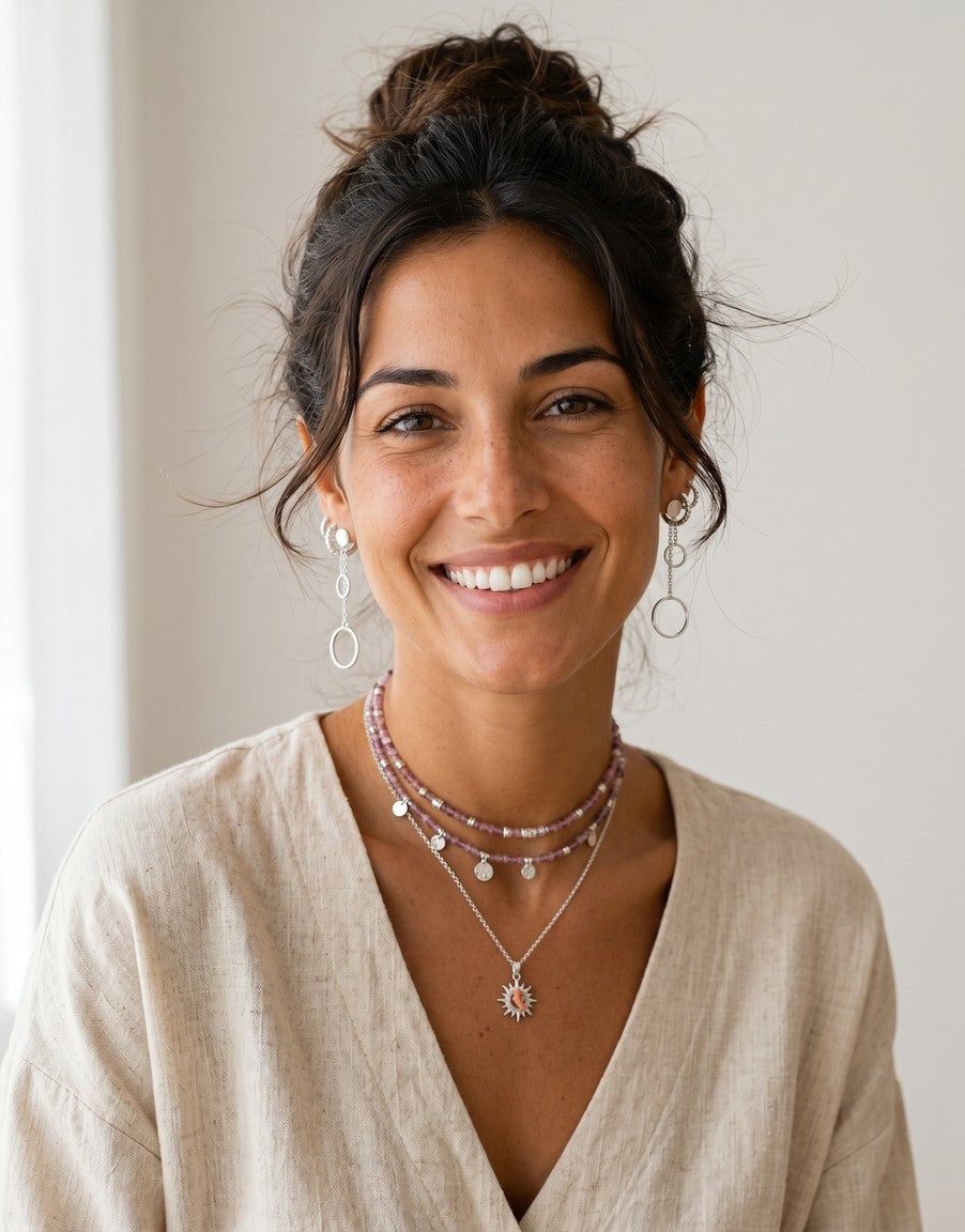 Pendientes Capri de plata de Calendula-shop con dos cadenas finas y círculos de distinto tamaño en una mujer sonriente