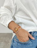 Pulsera artesanal Calendula-shop de plata de ley 925 con piedras naturales de cornalina en tonos naranja y amarillo.